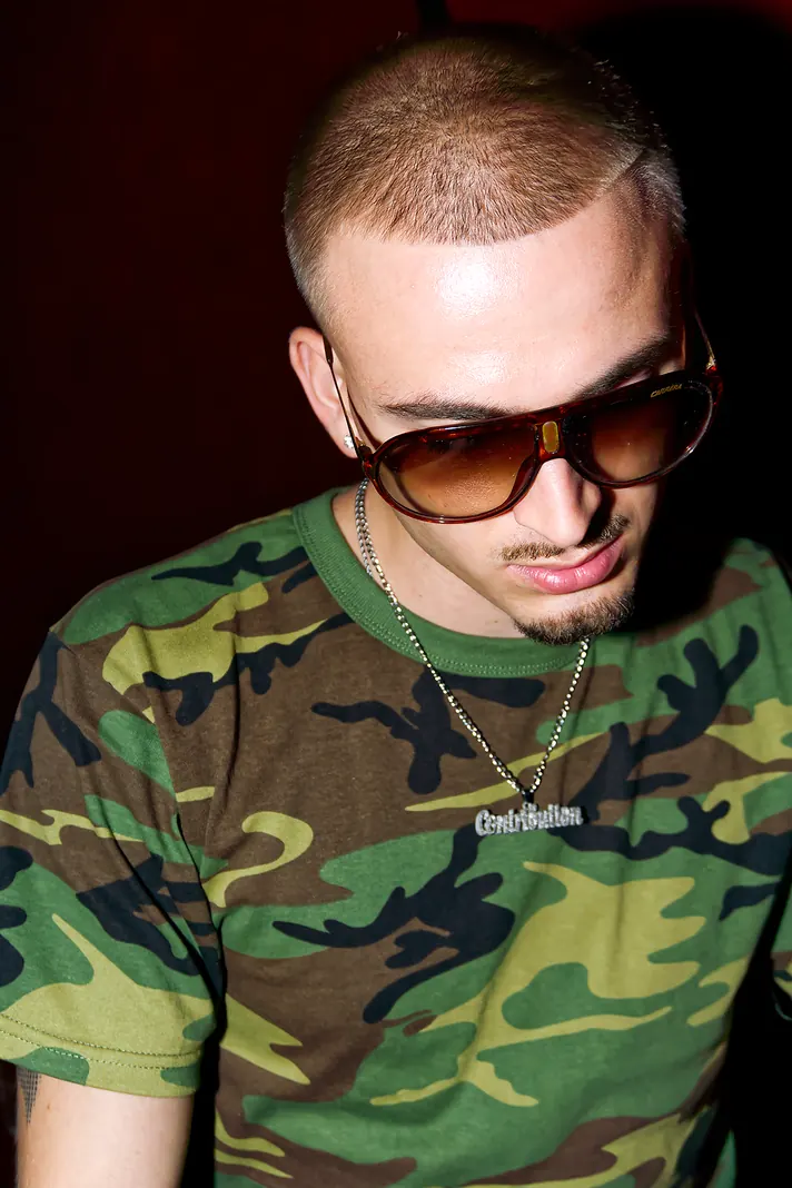 Close-up of Berjyy in aviator sunglasses and a camo t-shirt